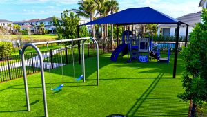 Akel Homes - Blue shaded playground with swings et