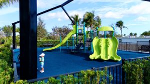 Avenir Clubhouse - Green and teal playground on blue turf